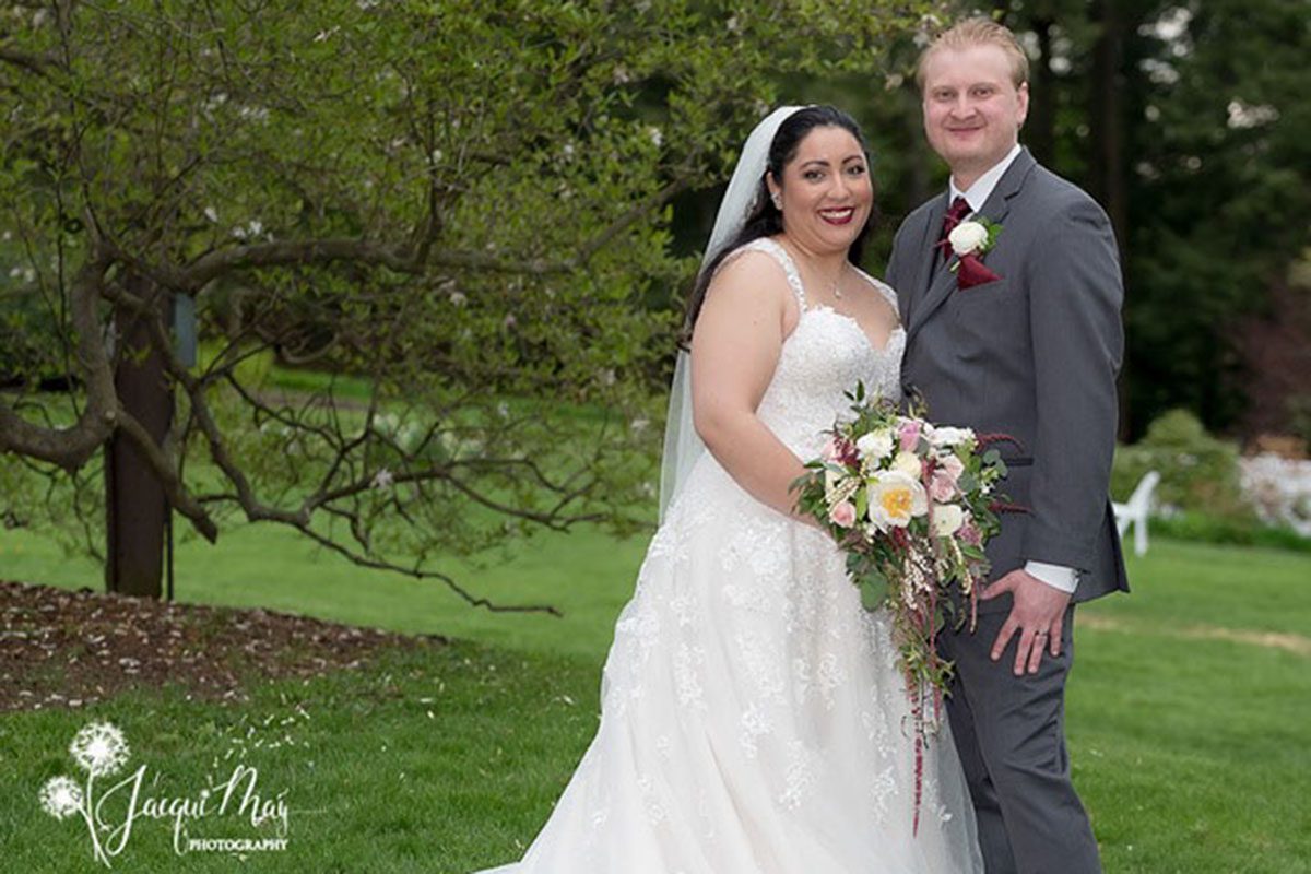 The May Wedding of Jenn and Paul may-wedding-couple-standing-together-on-lawn